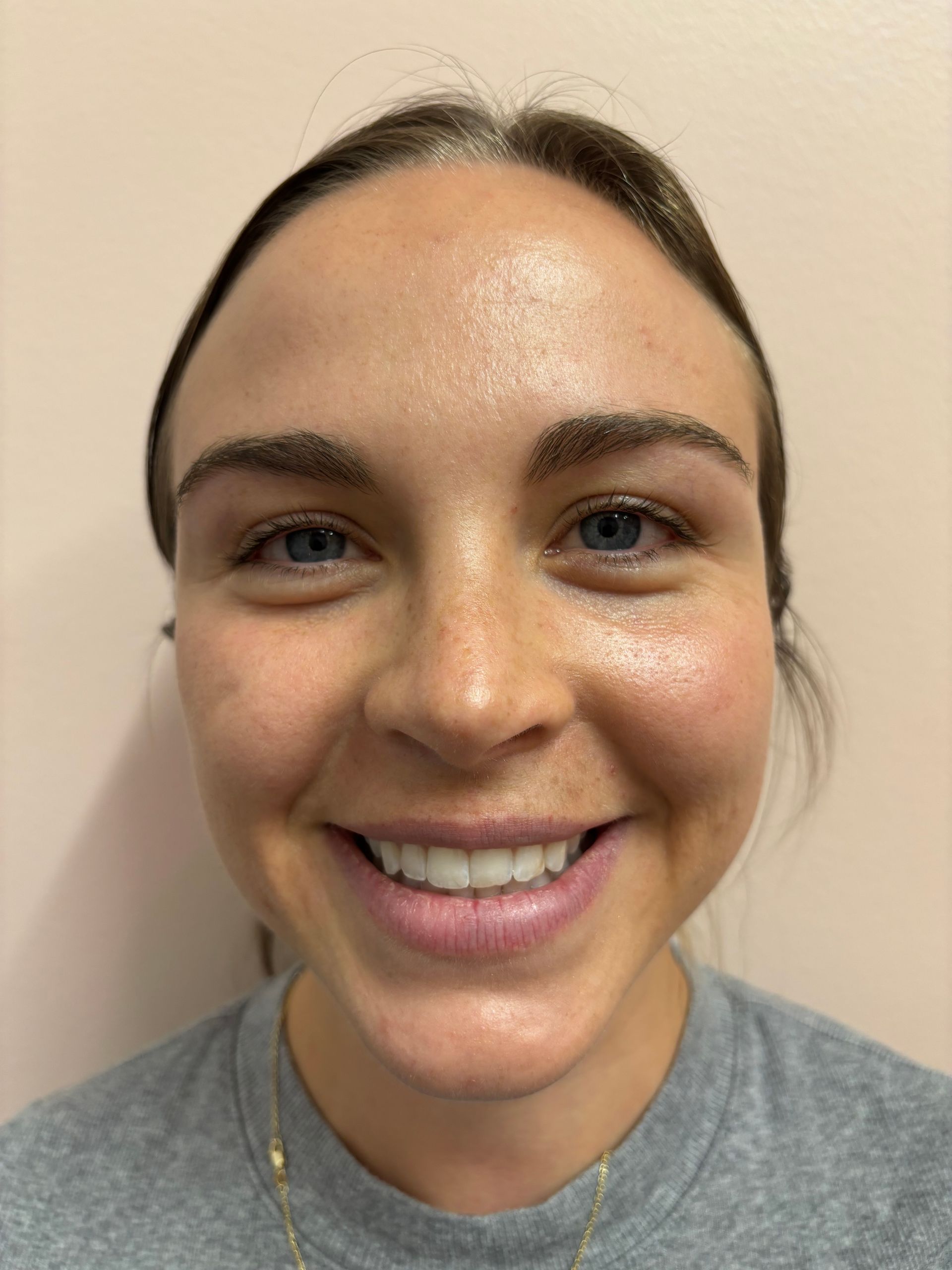 A close up of a woman 's face with a smile on her face.