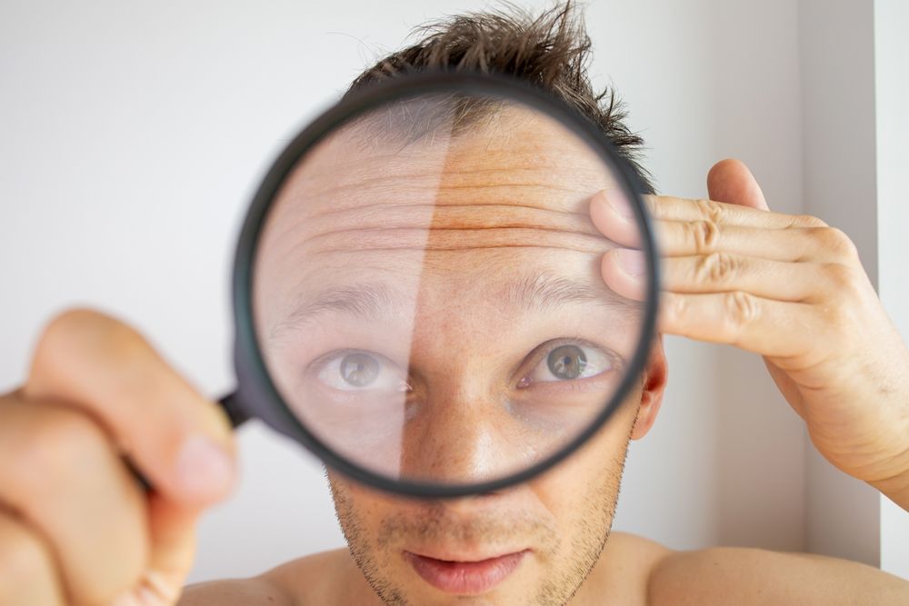 A woman is getting a botox injection in her face.
