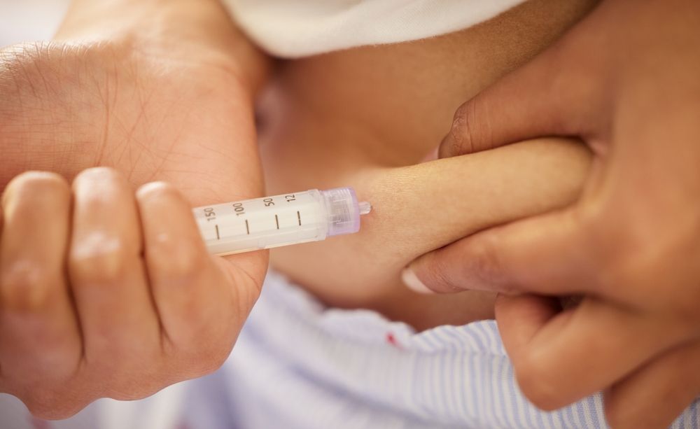 A woman is getting a botox injection in her face.