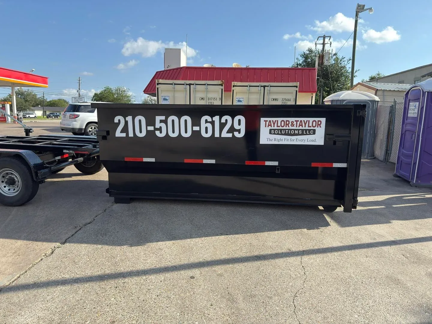 A group of construction workers are standing outside of a building.