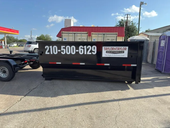 A group of construction workers are standing outside of a building.