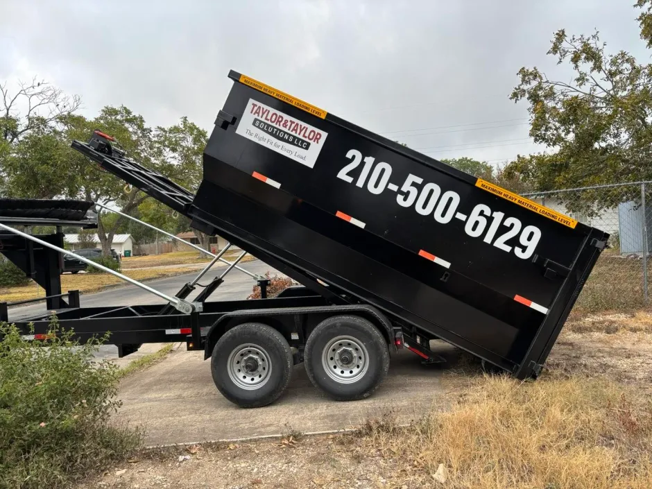 A dumpster is sitting in front of a building under construction.