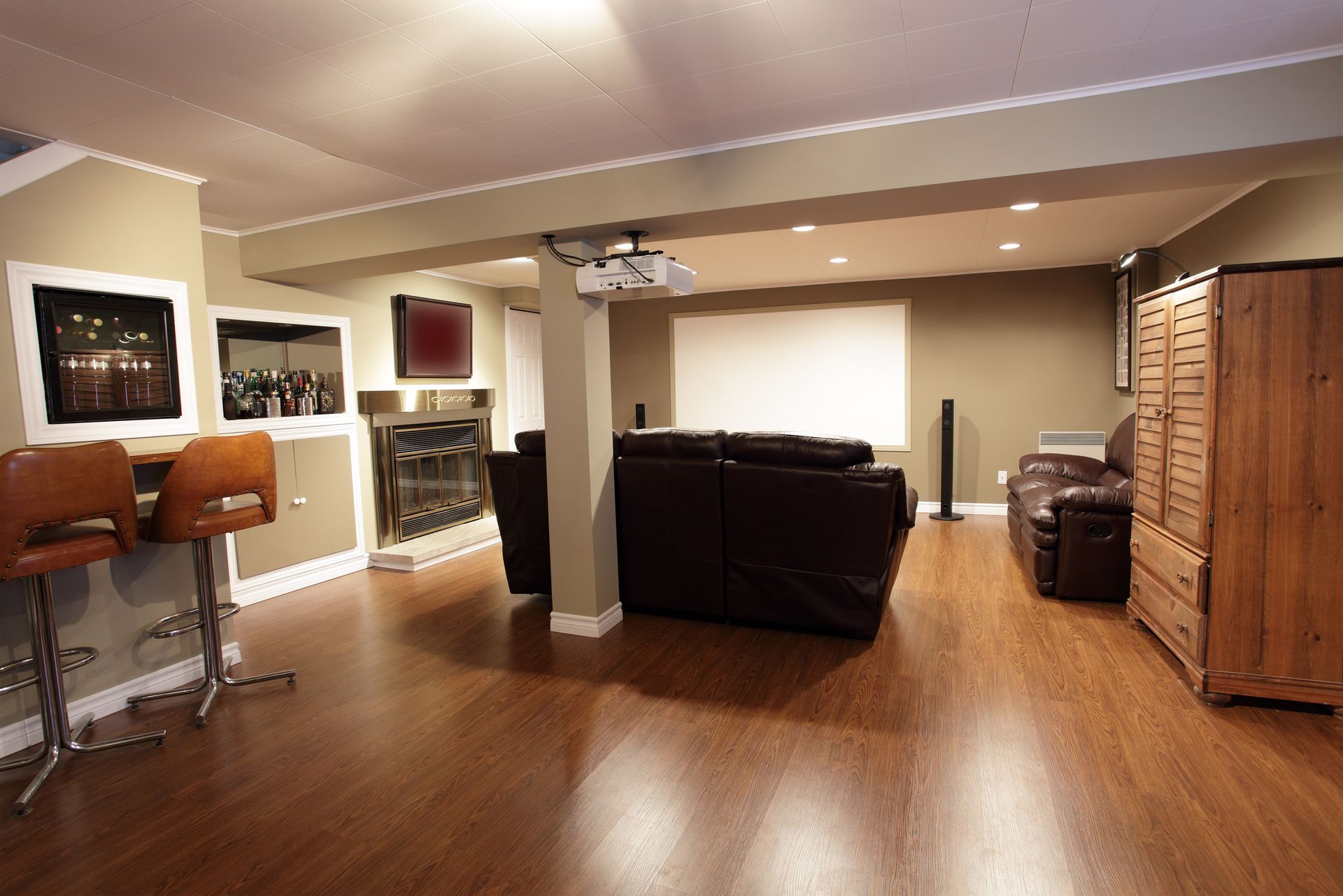 A basement with hardwood floors and a projector screen