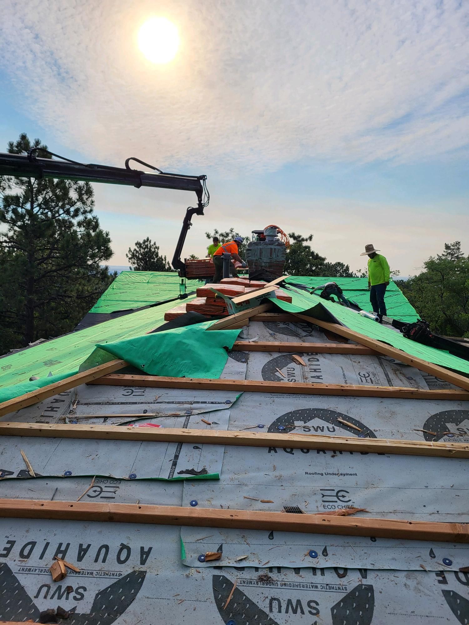 Residential roofer worker installing new roof.