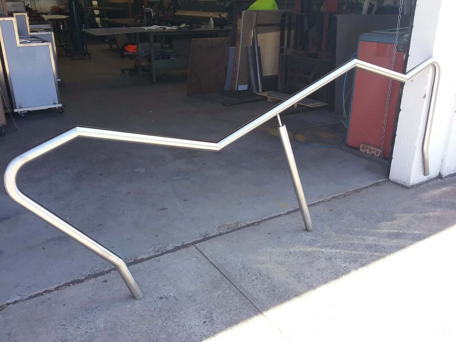 Metal Handrail Against a Concrete Surface With Two Supporting Posts — Highlander Metals in Kirrawee, NSW