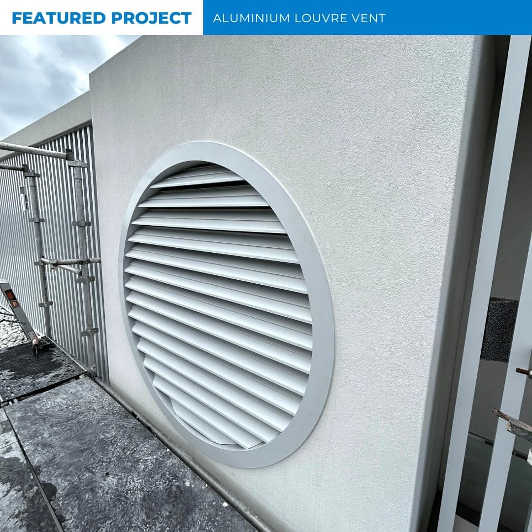 Aluminum Louver Vent Set Into a White Wall. the Vent is Round With a Silver Frame — Highlander Metals in Kirrawee, NSW