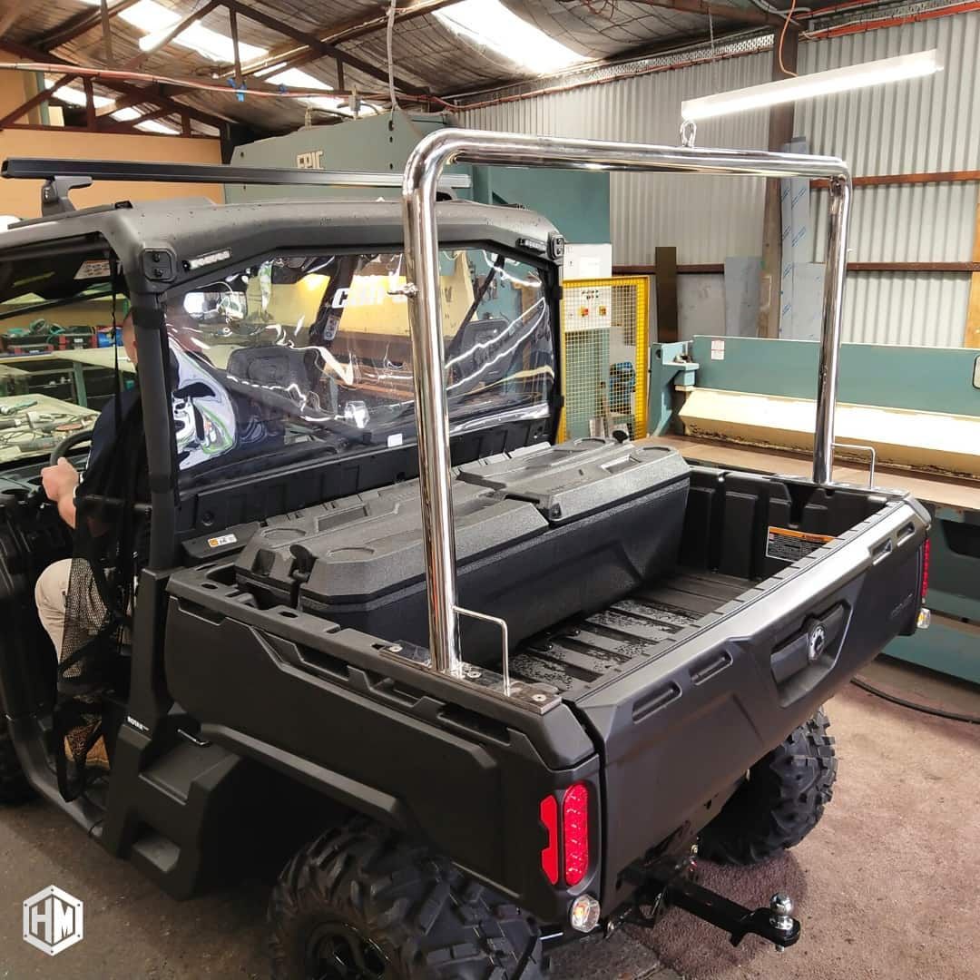 A black UTV in a workshop features a custom chrome roll bar over the truck bed with an attached horizontal light bar — Highlander Metals in Sutherland Shire, NSW