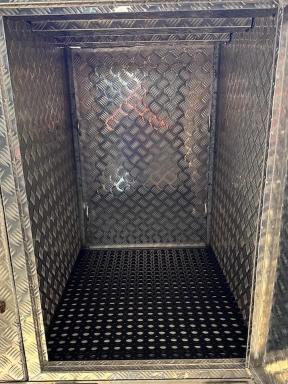 Empty storage compartment made of silver diamond-plate metal with a black perforated floor grate — Highlander Metals in Kirrawee, NSW