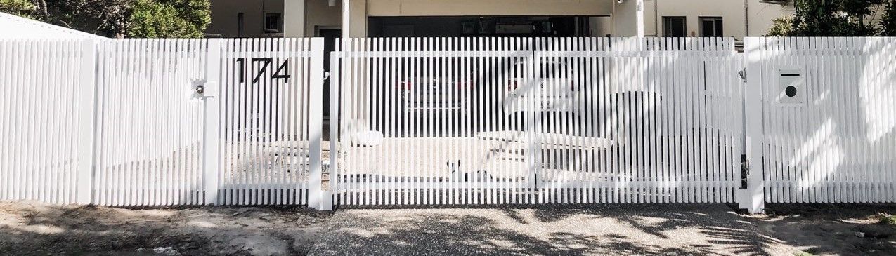 A white metal picket fence with the number 174 on the left side, positioned in front of a residential property — Highlander Metals in Kirrawee, NSW