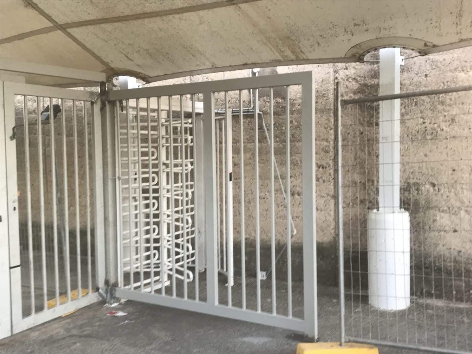 White Metal Turnstile Gate at a Building Entrance — Highlander Metals in Kirrawee, NSW
