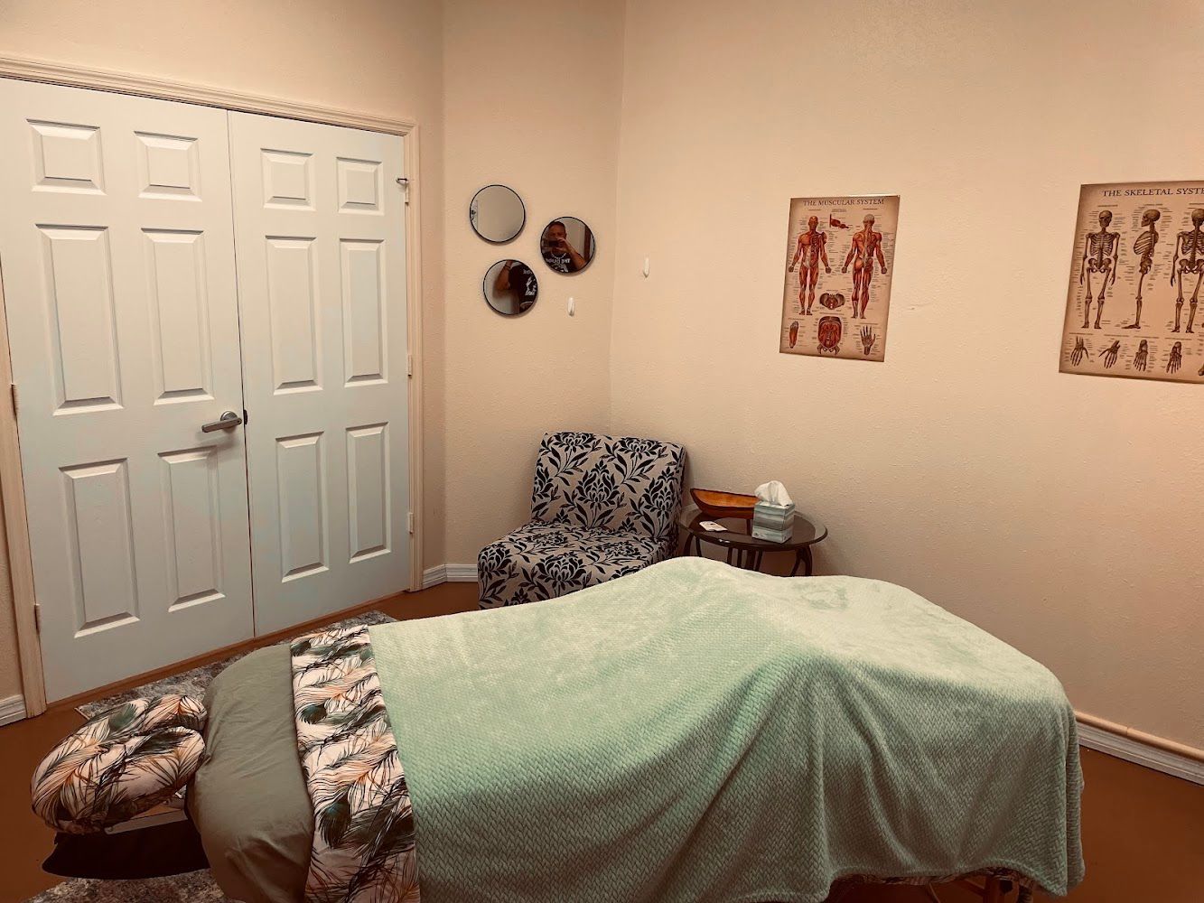 There is a massage table in the middle of the room.