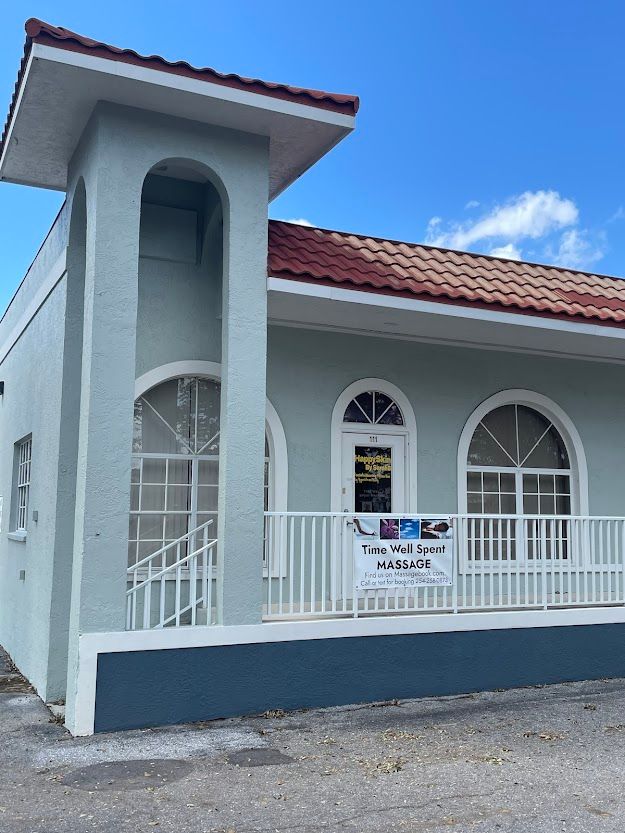 A white building with a red tile roof