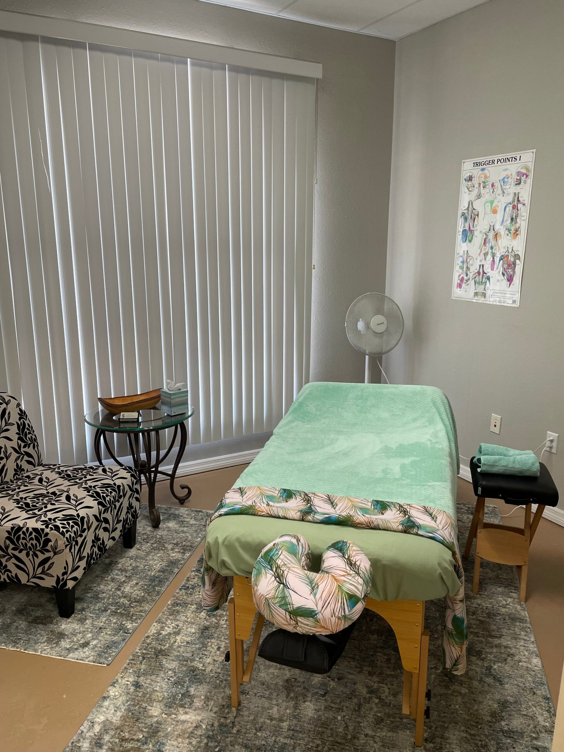 There is a massage table in the middle of the room.