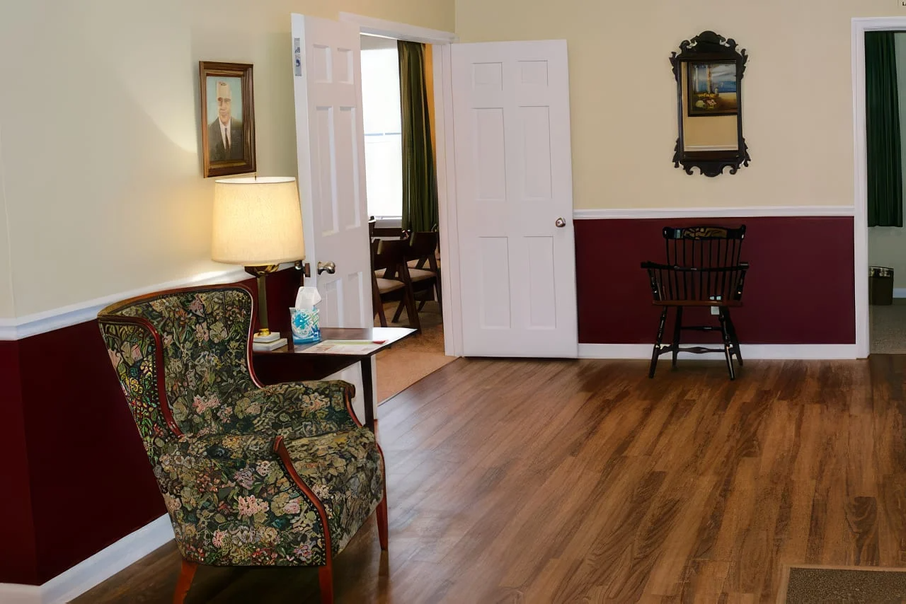 A living room with two chairs and a lamp