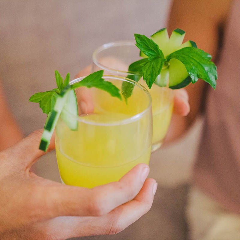 Refreshing tropical cocktail with mint garnish served poolside at an island resort