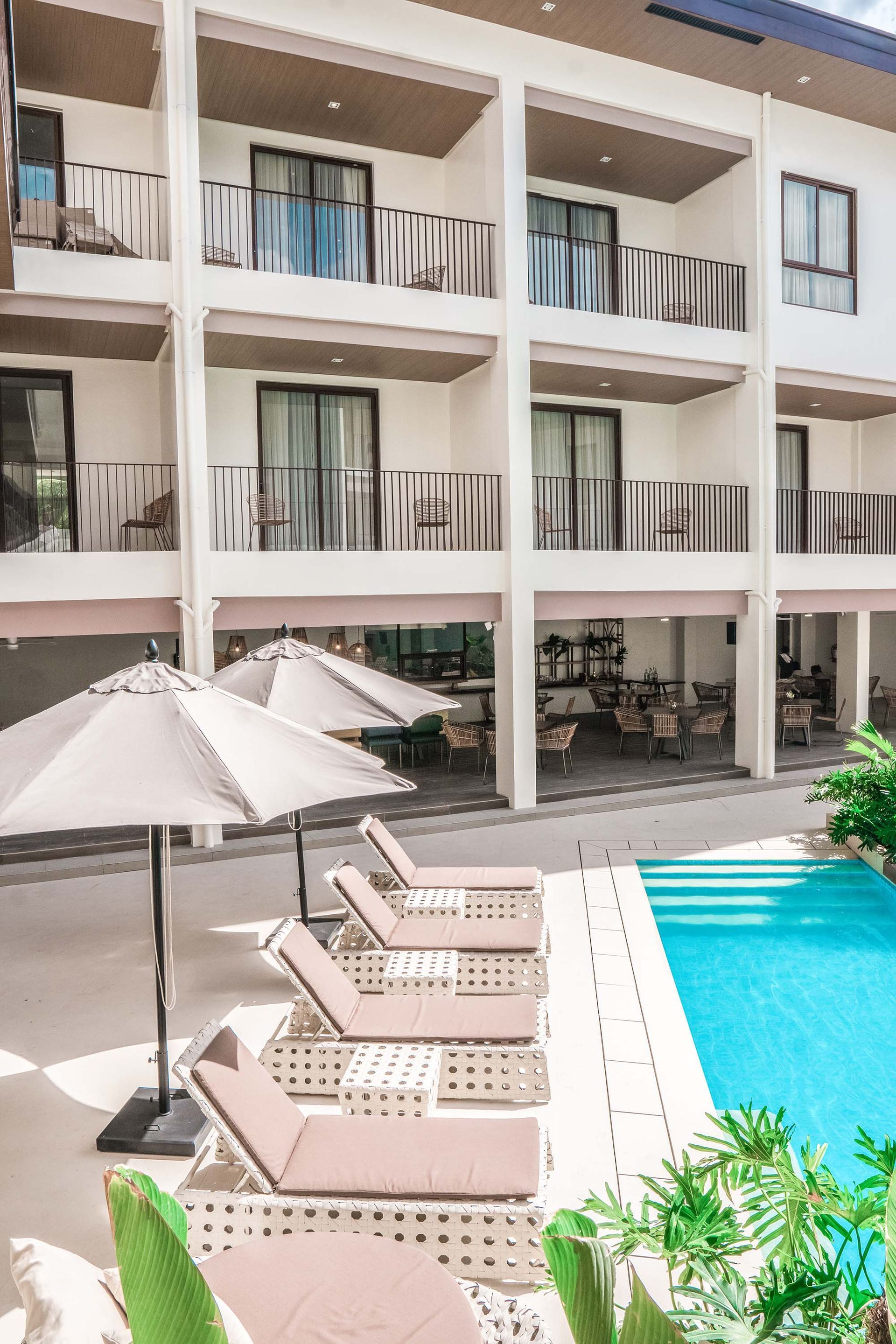 Charlie's El Nido resort pool with sun loungers and balconies