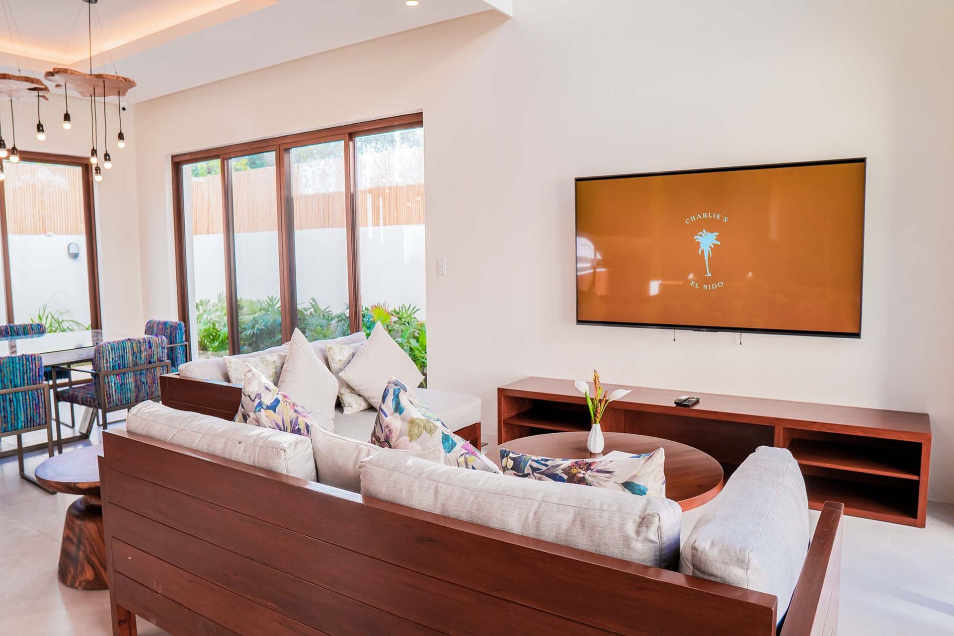 Charlie's Villa with a couch and a flat screen tv on the wall.