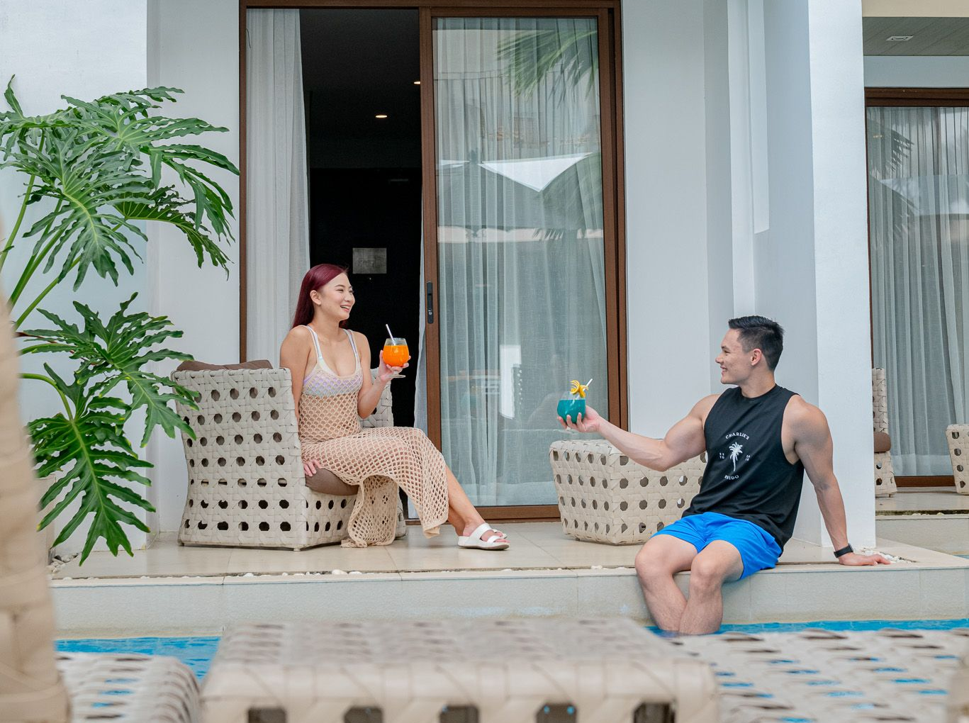Couple seated on a private balcony at Charlie's El Nido