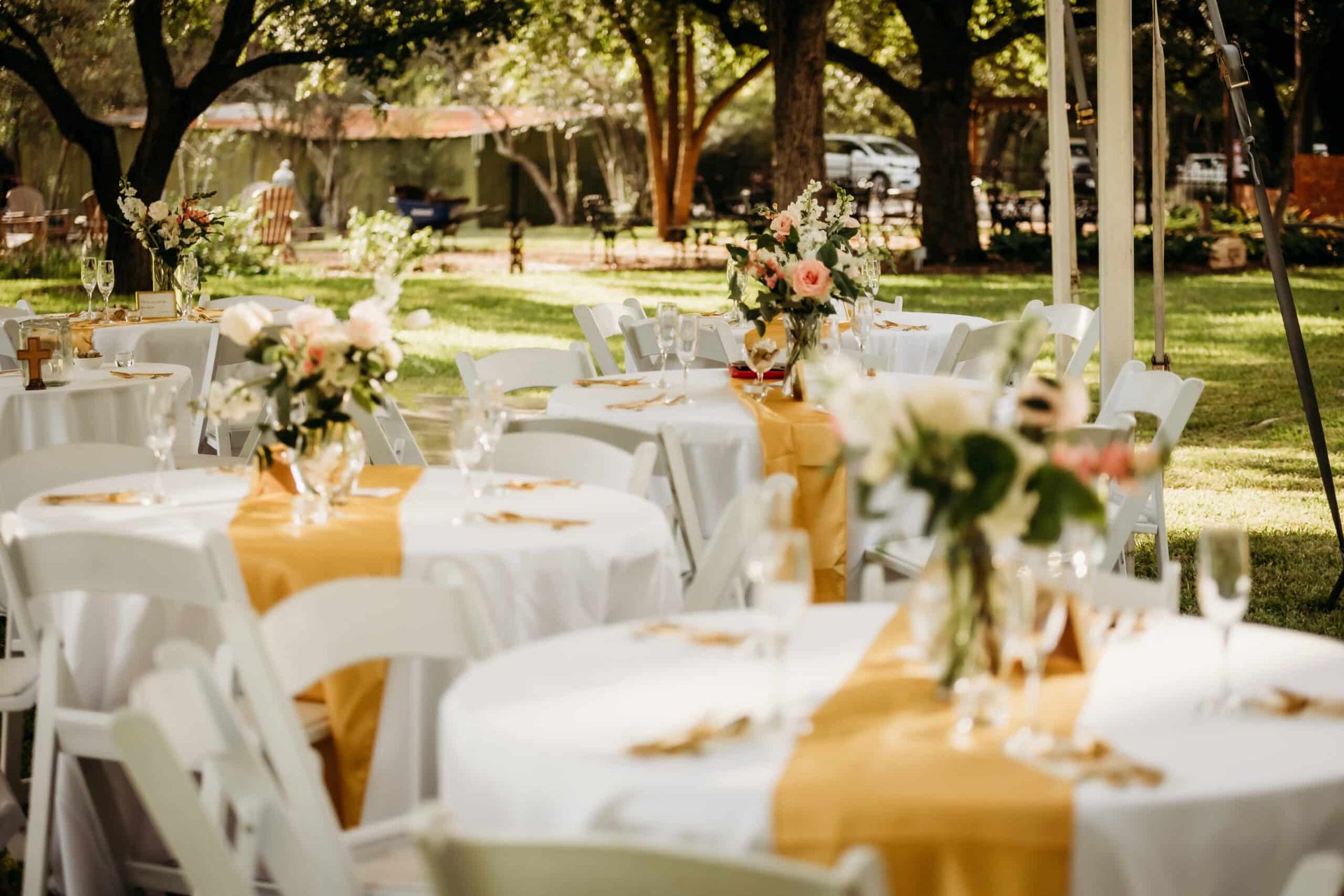 A bunch of tables and chairs set up for a wedding reception.