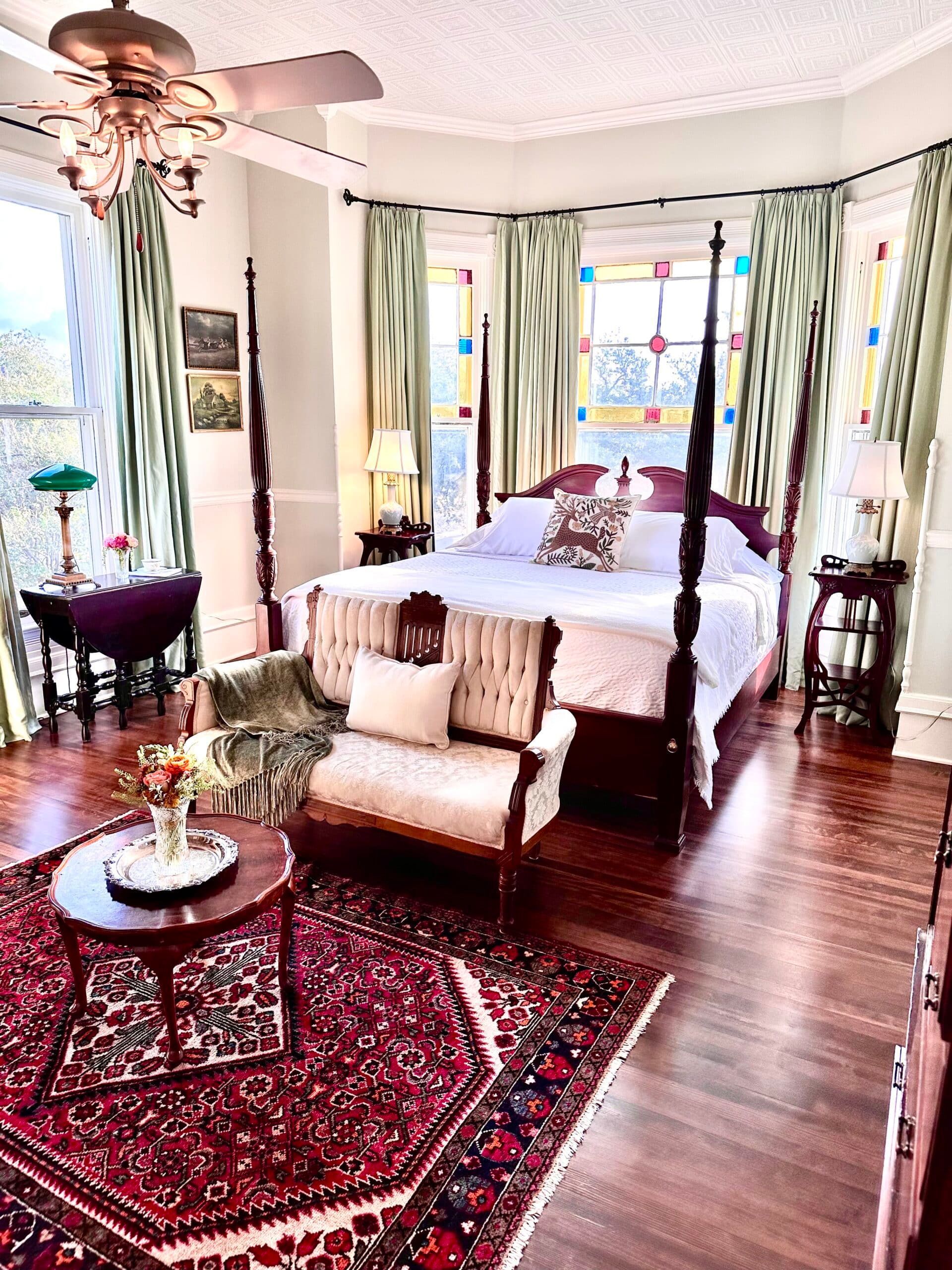 There is a four poster bed in the middle of the room.