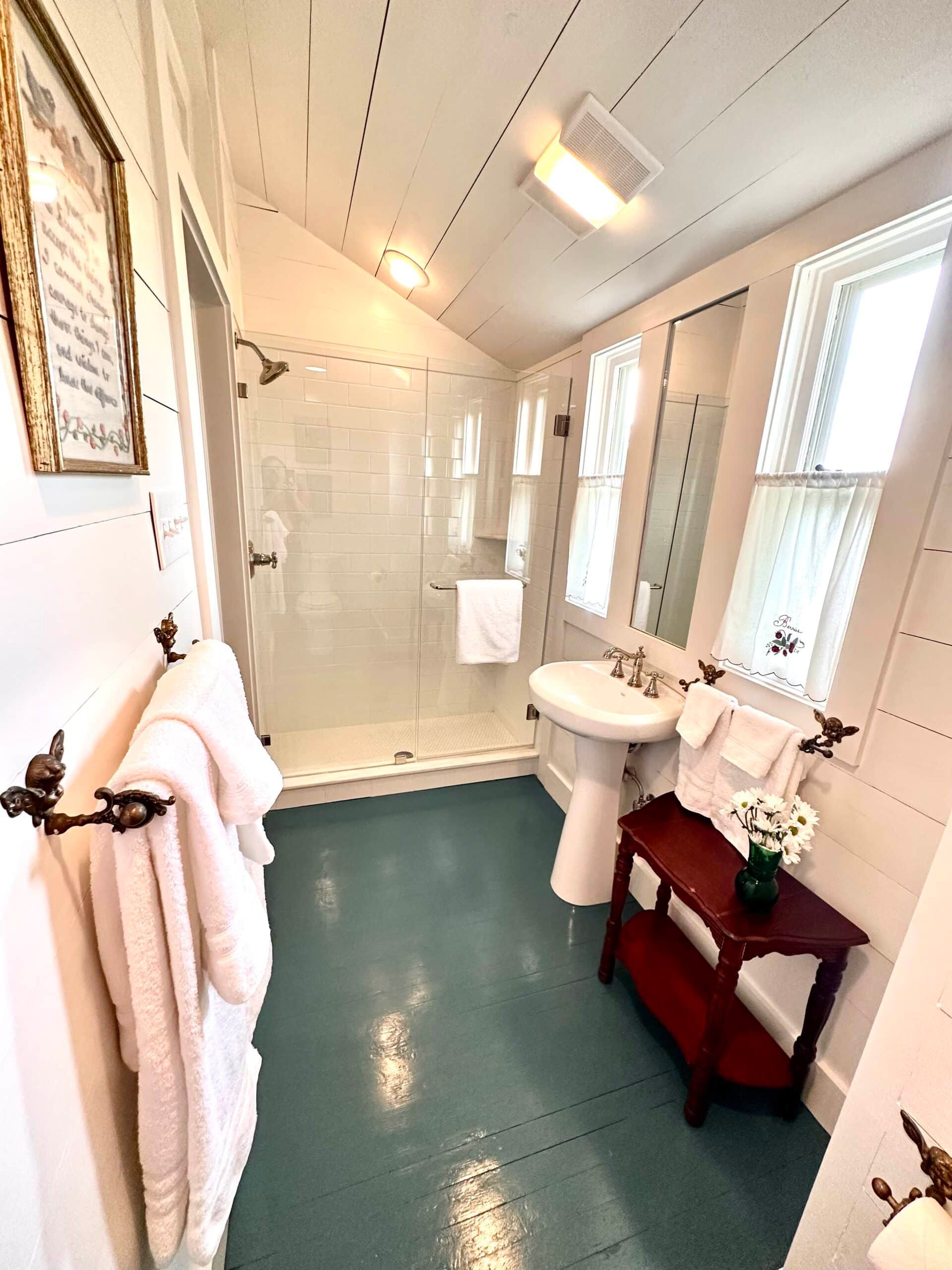 A bathroom with a sink and a walk in shower