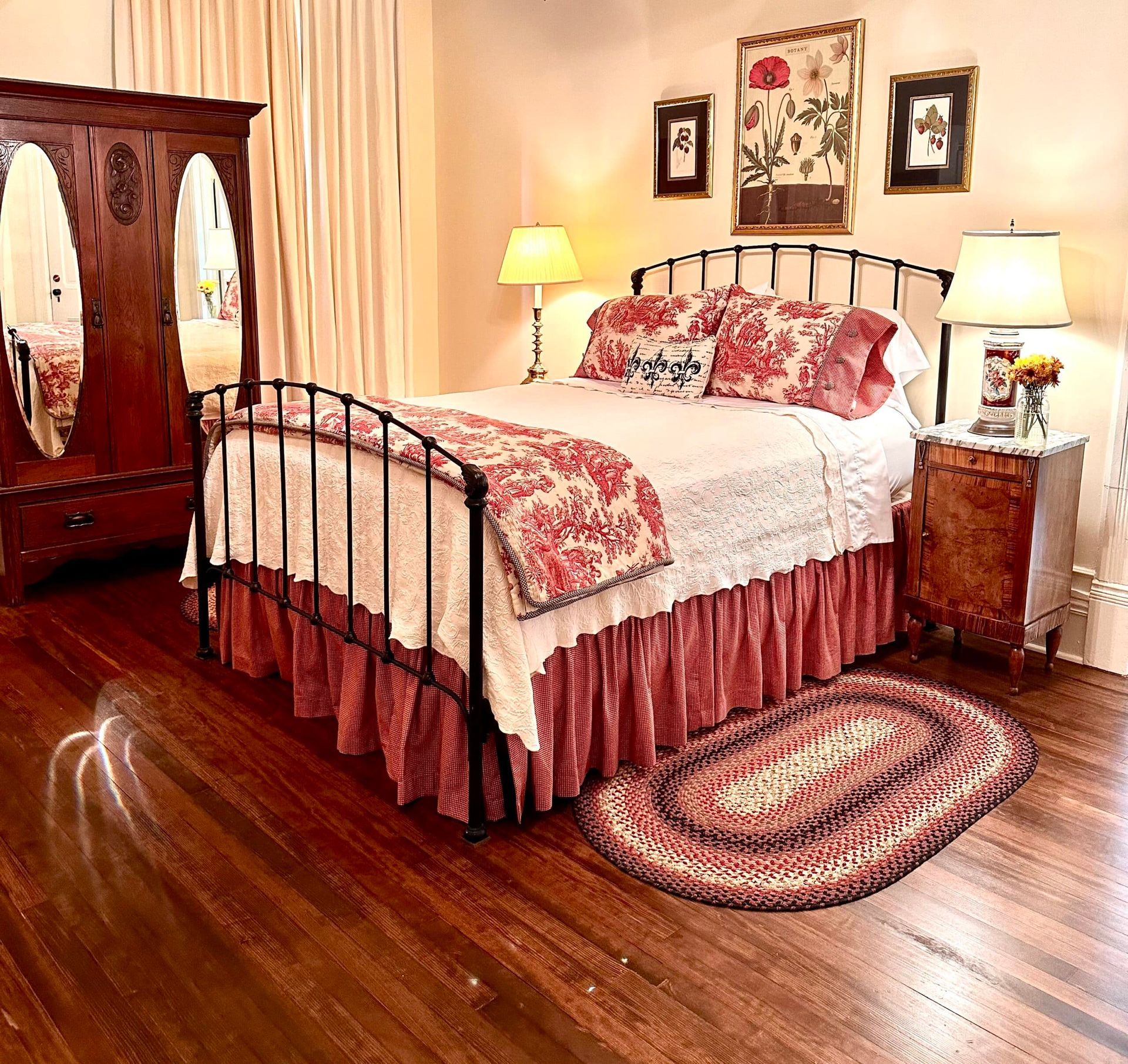 A bedroom with a bed and a rug on the floor