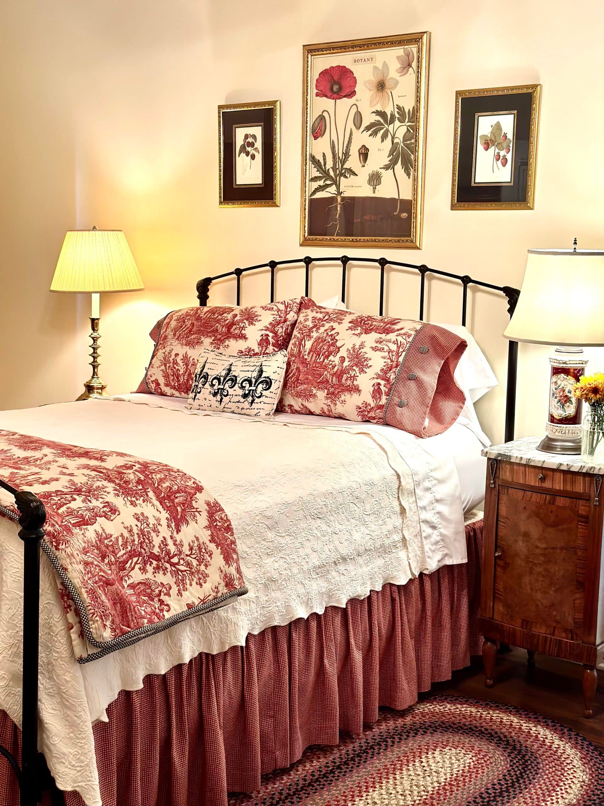 A bedroom with a bed , nightstand , lamp and rug