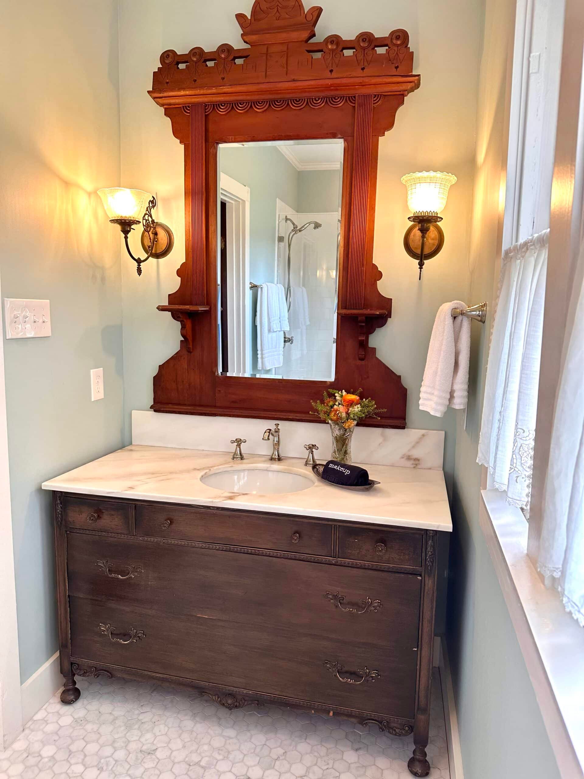 A bathroom with a sink a mirror and a window