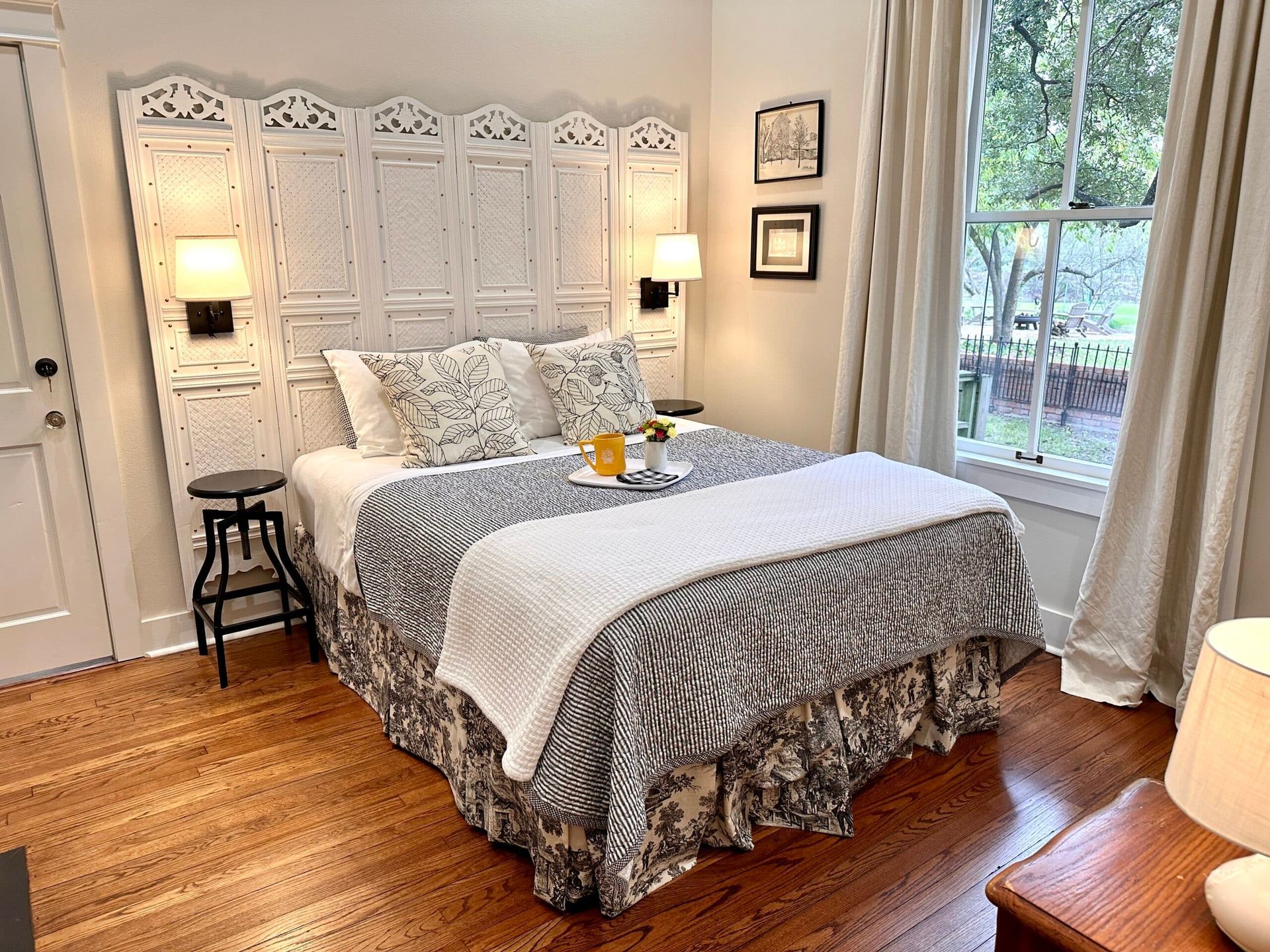 A bedroom with a large bed and a window.