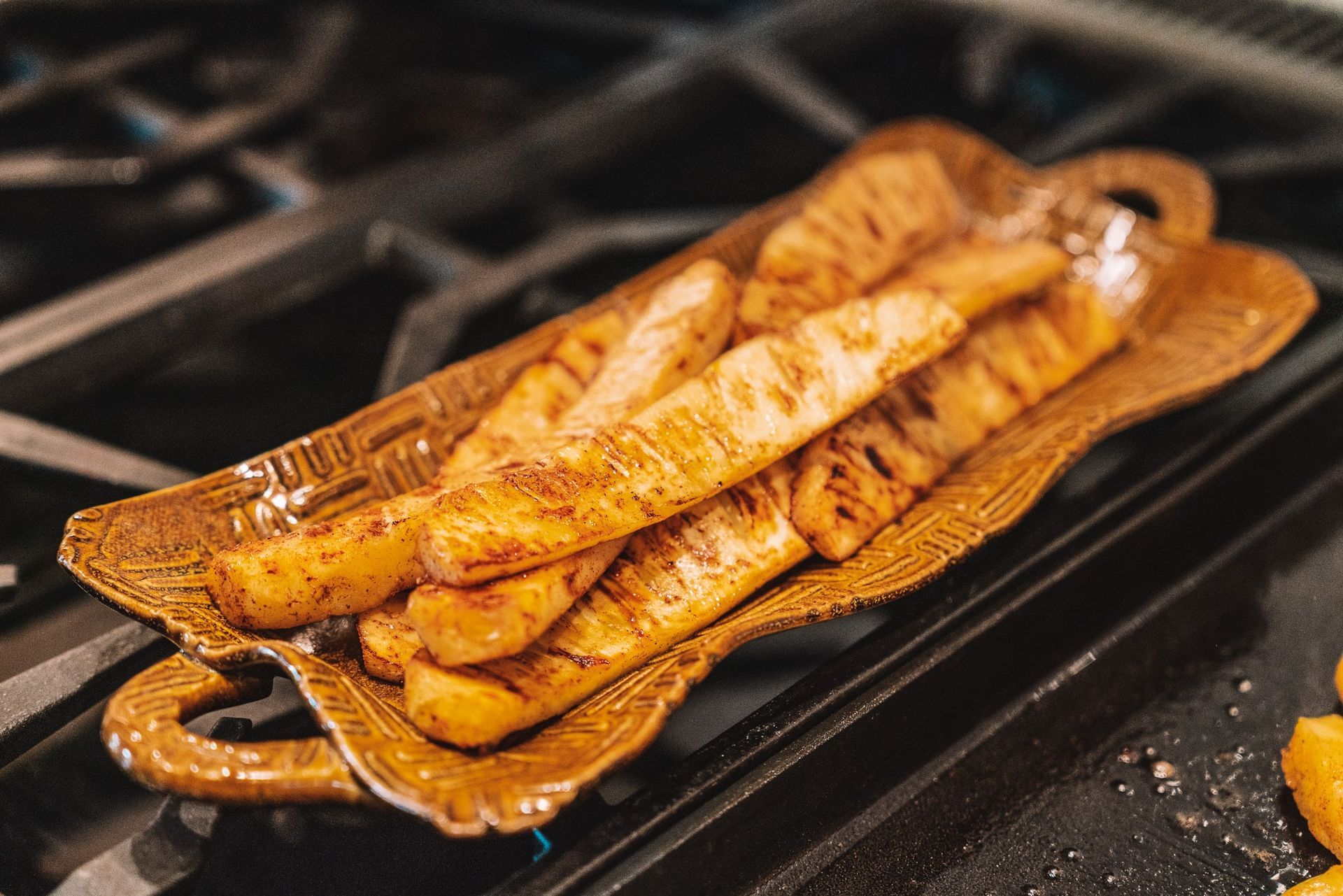 A plate of food is sitting on top of a stove.