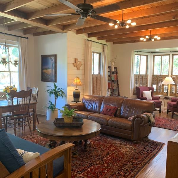 A living room with a couch a table and chairs