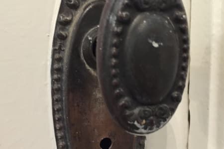 A close up of a door knob on a white door.