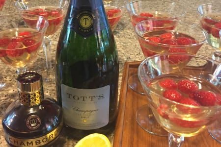 A bottle of champagne and a bottle of chamberlain champagne are on a table.