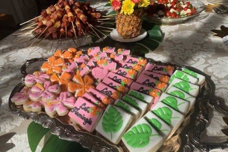A silver tray filled with different types of cookies on a table.