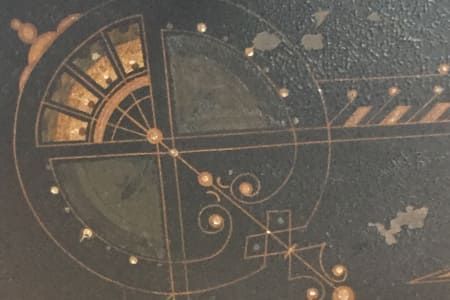 A close up of a clock with a circular design on it.