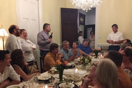 A group of people are sitting at a table in a room.