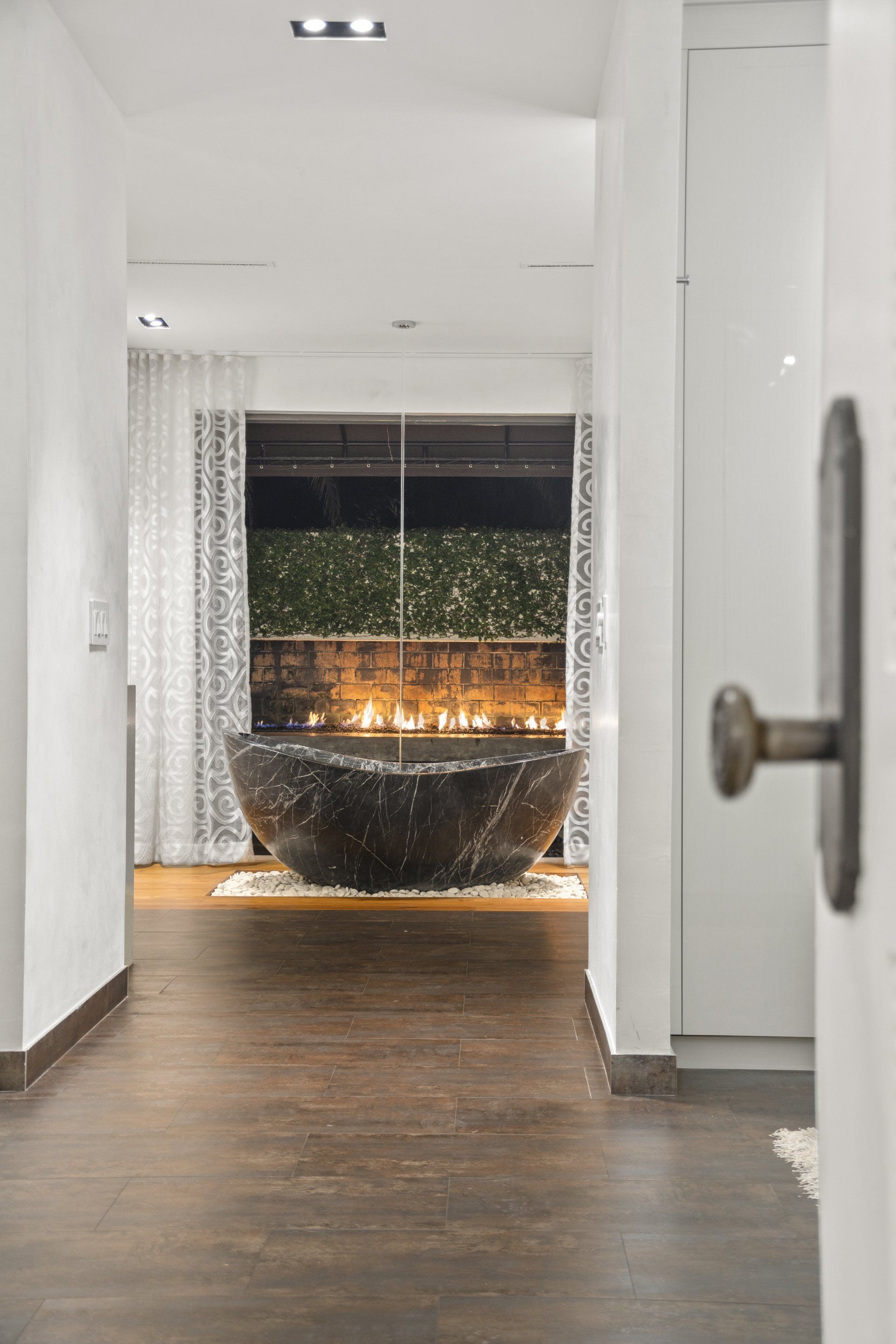 There is a large bathtub in the middle of the hallway.
