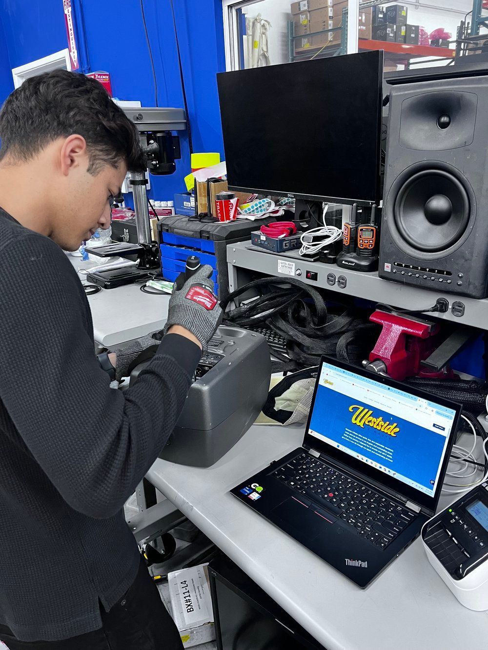 A man is working on a laptop that says ultimate on the screen