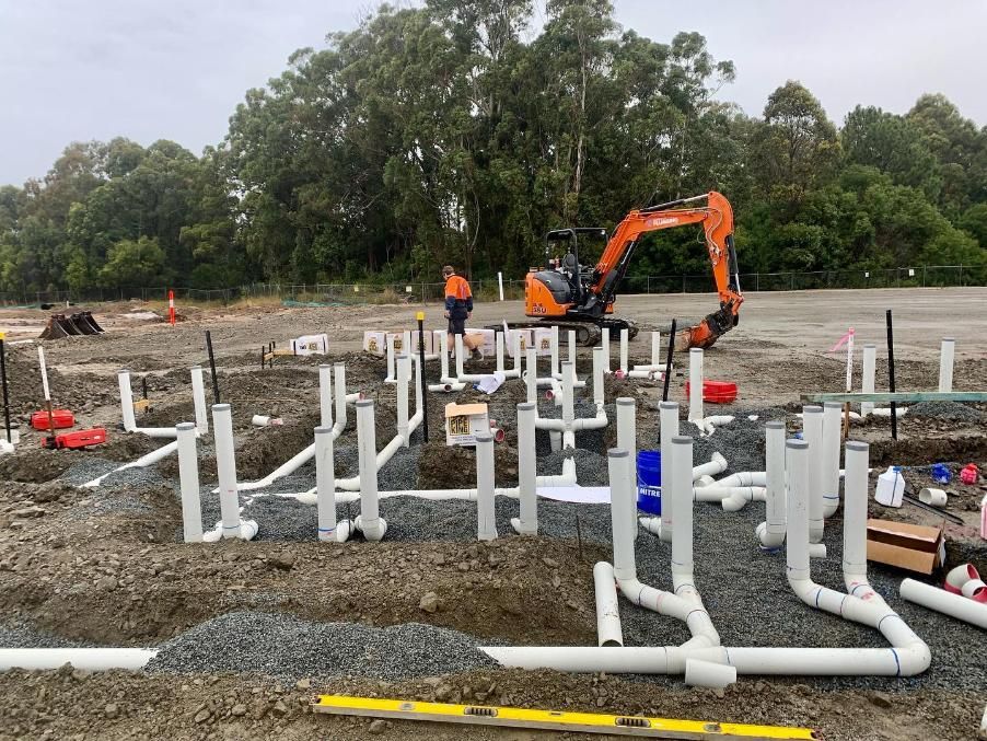 Plumbing Pipes and Fittings Laid Out on a Construction Site — Nambucca Plumbing in Port Macquarie, NSW