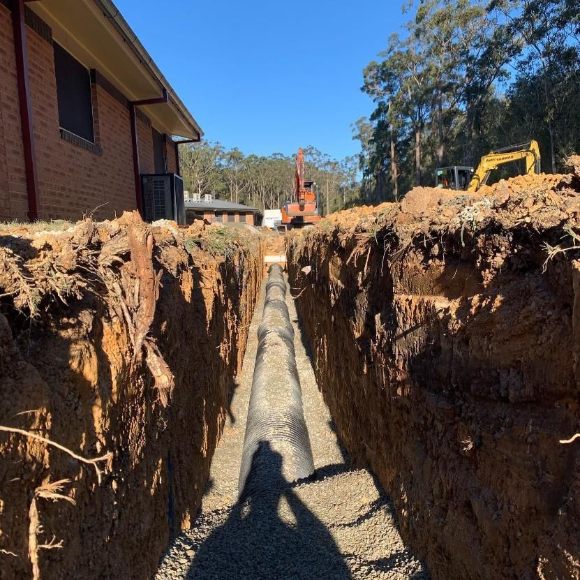 A Trench With a Gravel-lined Pipe Being Installed — Nambucca Plumbing in Wauchope, NSW