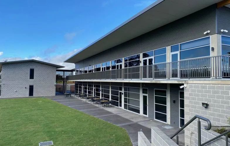 A Large Building with A Lot of Windows and Stairs Leading up To It — Nambucca Plumbing in Nambucca Heads, NSW