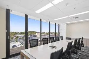 A Conference Room with A Long Table and Chairs and A Lot of Windows — Nambucca Plumbing in Nambucca Heads, NSW