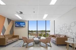 A Living Room with A Couch, Chairs, Table and Television — Nambucca Plumbing in Nambucca Heads, NSW