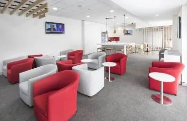 A Living Room Filled with Red and White Chairs and Tables — Nambucca Plumbing in Nambucca Heads, NSW