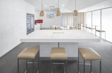 A Kitchen with A Table and Stools in It — Nambucca Plumbing in Nambucca Heads, NSW