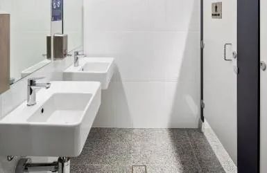 A Bathroom with Two Sinks, a Mirror and A Door — Nambucca Plumbing in Nambucca Heads, NSW