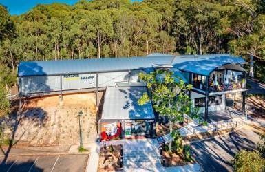 An Aerial View of A Large Building in The Middle of A Forest — Nambucca Plumbing in Nambucca Heads, NSW