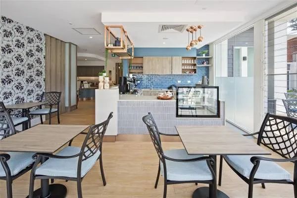 A Restaurant with Tables and Chairs and A Counter — Nambucca Plumbing in Nambucca Heads, NSW