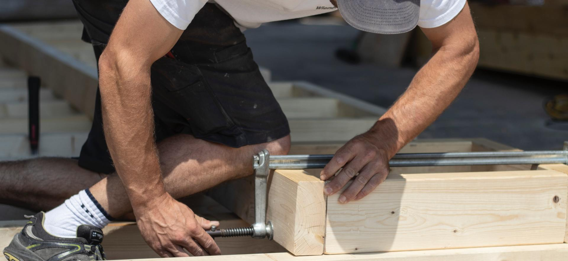 Roofer in the summer repairing a roof