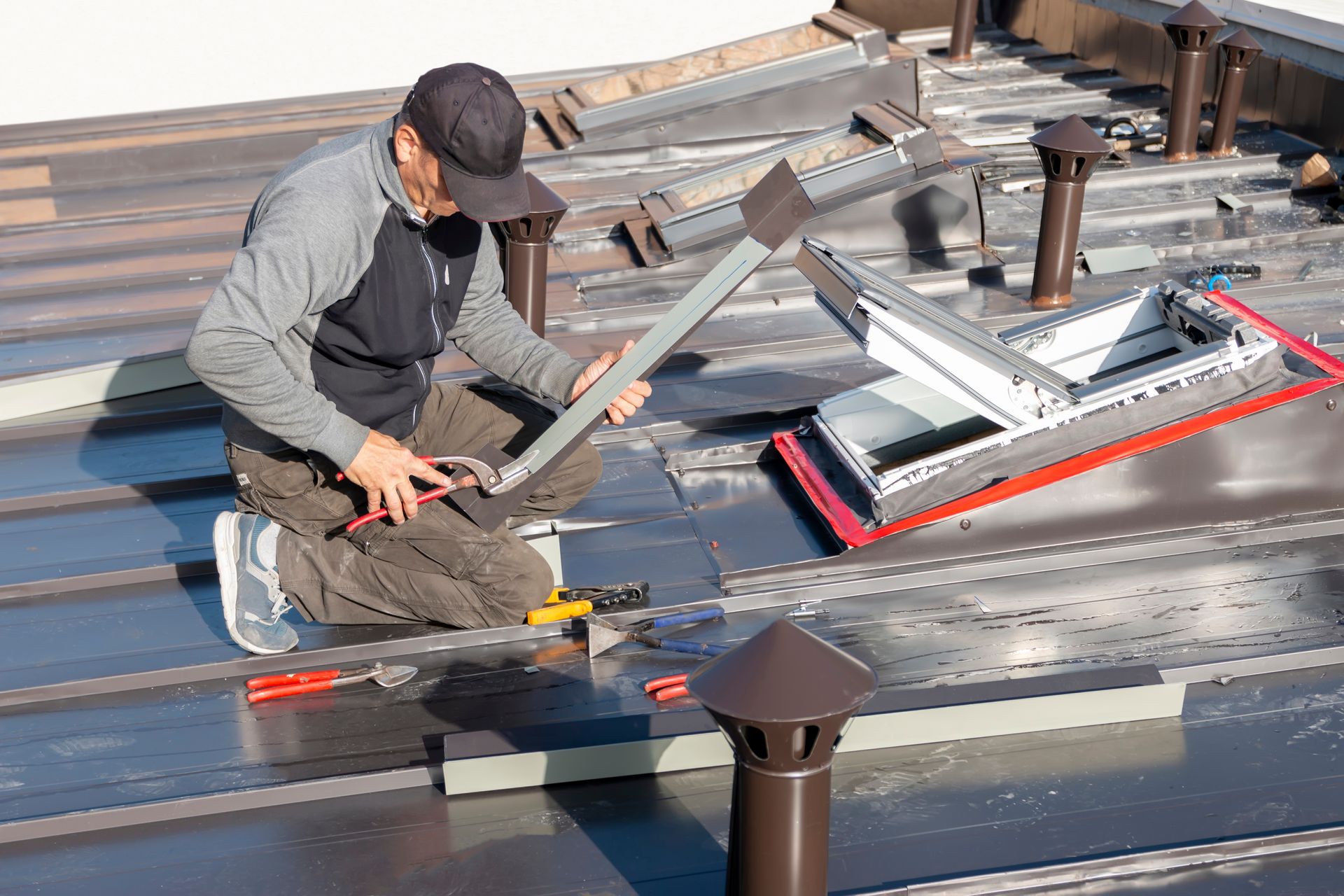 A man is working on the roof of a building.